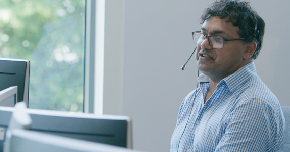 Crawley contact centre employee looking at computer screens.