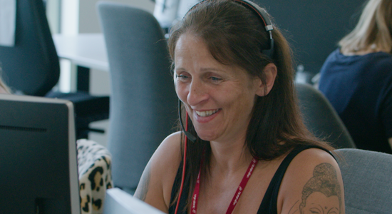 Crawley contact centre employee smiling at screen