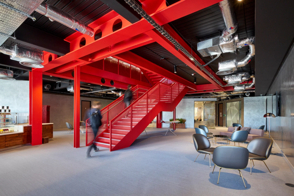 Interior of a Virgin Atlantic office with striking red stairs and chairs