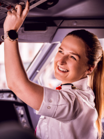 Virgin Atlantic pilot in flight deck preparing aircraft controls before departure