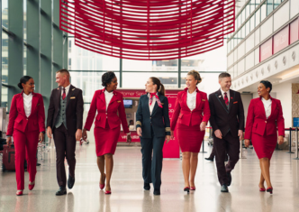 A group of Virgin Atlantic crew members and pilots walking through an airport terminal.