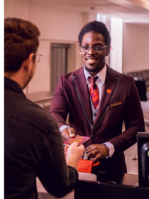 Virgin Atlantic customer service team member speaking with a passenger at the airport