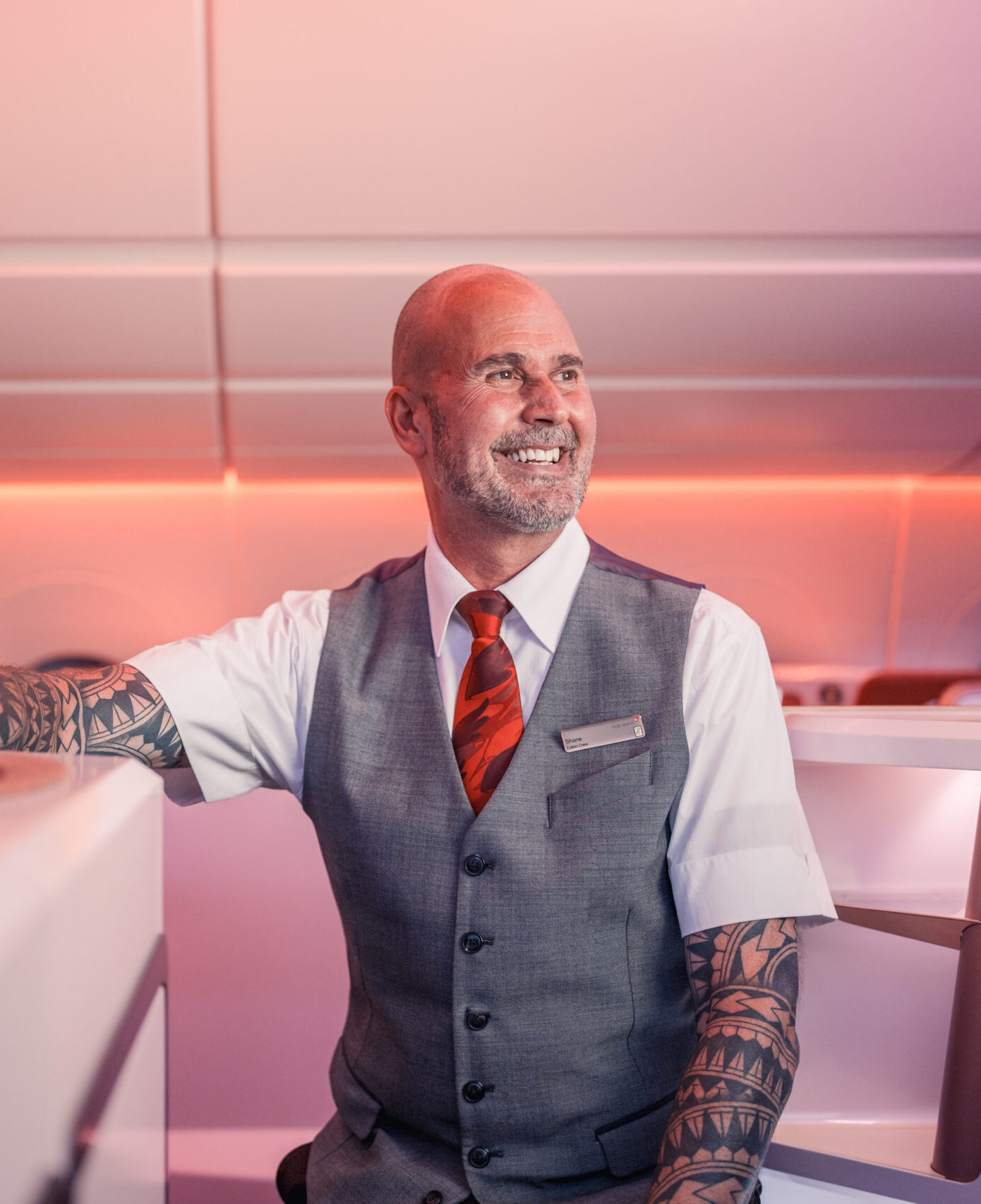 Virgin Atlantic cabin crew member smiling in uniform on board