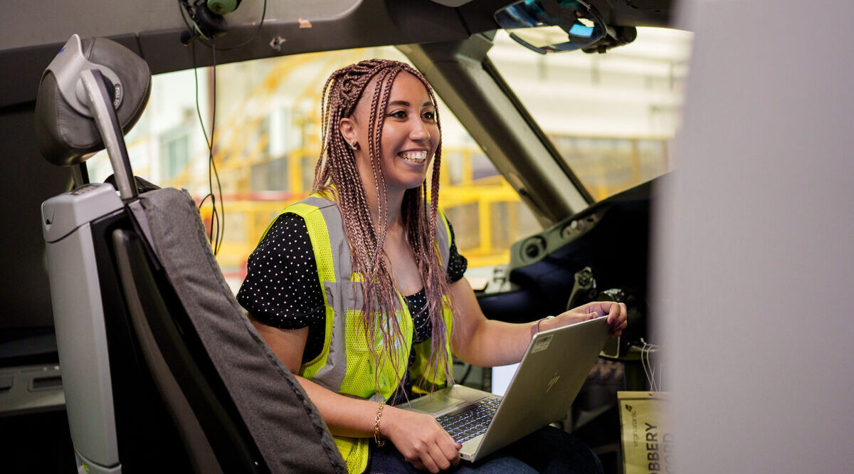 Virgin Atlantic employee sitting with a laptop